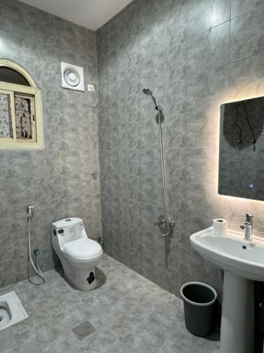 a bathroom with a toilet and a sink at نزل العلا in AlUla