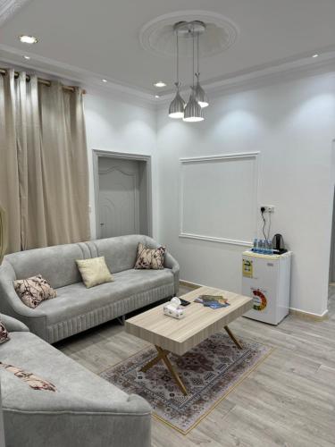 a living room with a couch and a coffee table at نزل العلا in AlUla