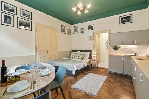 a room with a bed and a table and a kitchen at APTs in OLD TOWN PRAGUE by Michal&Friends in Prague