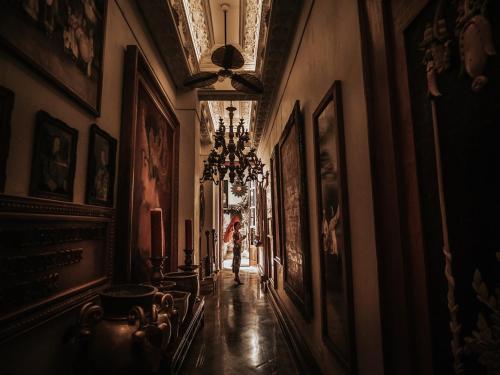 a person walking down a hallway in a building at House of Tugu, Old Town Jakarta in Jakarta