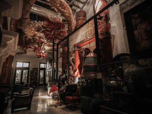 a room filled with lots of chairs and a room with a room at House of Tugu, Old Town Jakarta in Jakarta