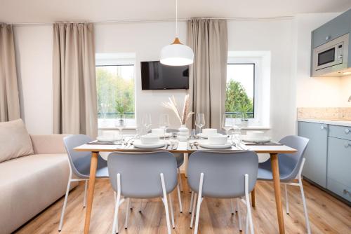 a kitchen and dining room with a table and chairs at DWELLSTAY - City Apartments Fulda in Fulda