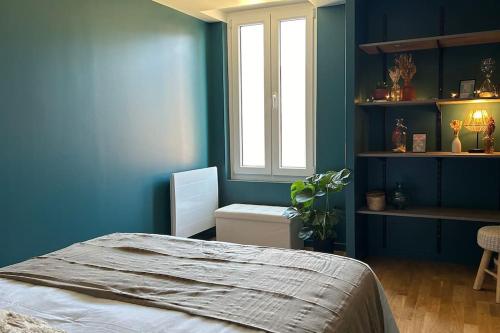 une chambre bleue avec un lit et une fenêtre dans l'établissement Appartement moderne et spacieux, à Lain