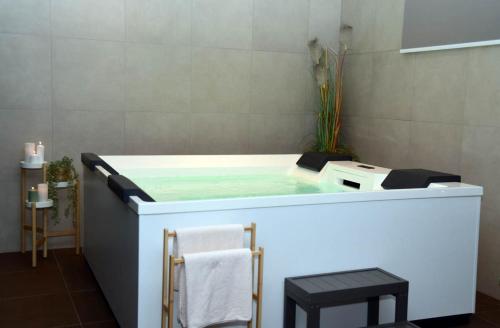 a bath tub with two stools in a bathroom at 5 Sunca in Kašina