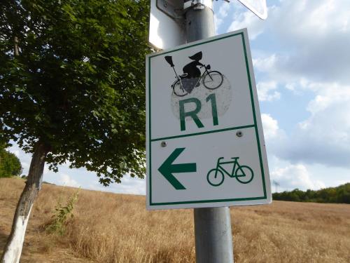 a sign on a pole with a bike on it at Teufelsmauer-Blick in Thale