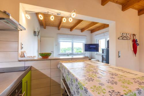 a kitchen with a table with a counter top at Teufelsmauer-Blick in Thale