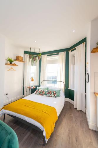 a bedroom with a bed with a yellow blanket at No 27 Liverpool in Liverpool