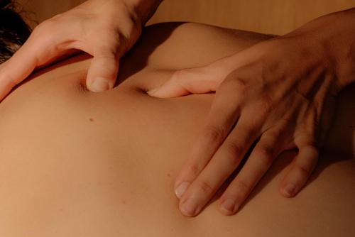 a woman with her hands on her stomach at Hotel Auerhahn in Schluchsee