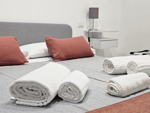 a bed with towels on top of it at Be Your Home - Guest House Il Ferroviere in Civitavecchia