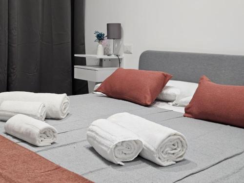 a bed with towels on top of it at Be Your Home - Guest House Il Ferroviere in Civitavecchia