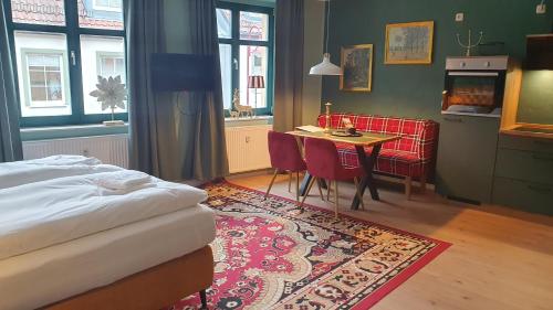a bedroom with a bed and a table and chairs at Der grüne Fürst Ferienwohnung Apartment 1 in Bad Muskau
