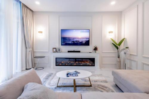 a living room with a couch and a fireplace at Karon Beach Residence in Karon Beach