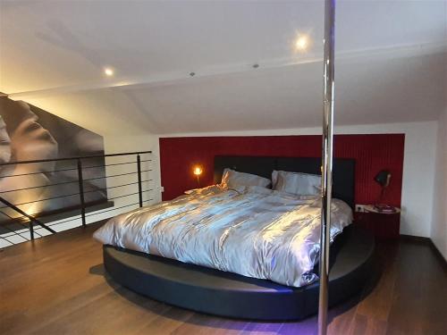 a bedroom with a bed in a round bed frame at Love room avec spa privatif in Ruelle-sur-Touvre