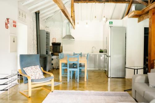 a kitchen and dining room with a table and chairs at Casa da Assudra in Vila Verde