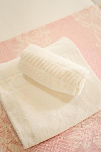 a white towel sitting on top of a table at Casa da Assudra in Vila Verde
