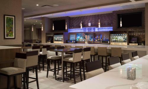 a bar in a restaurant with bar stools at Hilton Washington DC/Rockville Hotel & Executive Meeting Center in Rockville
