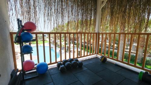 a balcony with dumbbells and a fence with a waterfall at Regia Mare Beach Hotel & Spa Bodrum in Ortakent