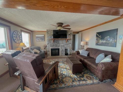 a living room with a couch and a fireplace at ML148 Corner Unit Fireplace WiFi Parking Connects To ML150 Rented Separately in Snowshoe