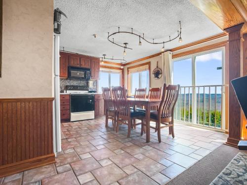 a kitchen with a table and chairs and a balcony at ML148 Corner Unit Fireplace WiFi Parking Connects To ML150 Rented Separately in Snowshoe