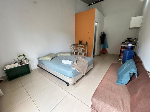 a bedroom with two beds and a table in it at Caminito Brasília Apto 02 in Luziânia
