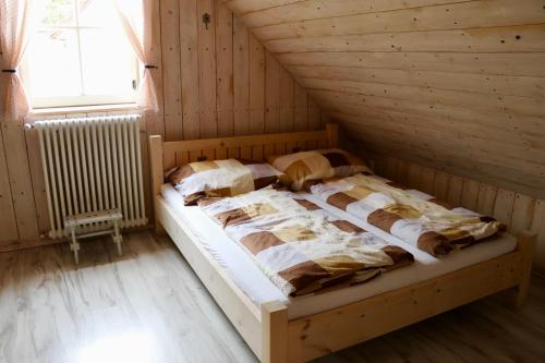 a room with two beds in a wooden cabin at Cifrovaná drevenička in Detva