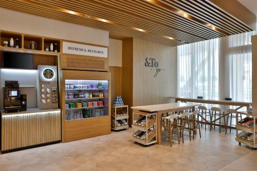 a restaurant with a table and chairs in a room at Hilton Garden Inn Dubai Business Bay in Dubai