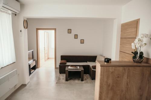 a living room with a couch and a table at Apartman Krznarić in Županja