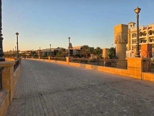 a bridge over a street with buildings in the background at Sahl Hasheesh, El Andalous by All View apartements in Hurghada