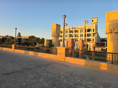 a fence in front of a building and a street at Sahl Hasheesh, El Andalous by All View apartements in Hurghada