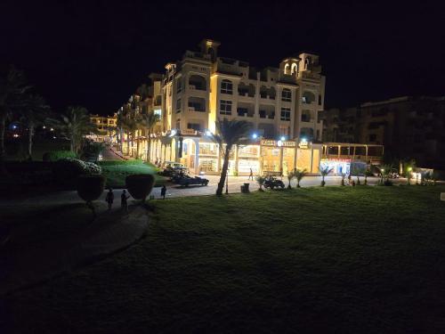 a large white building at night with lights at Sahl Hasheesh, El Andalous by All View apartements in Hurghada