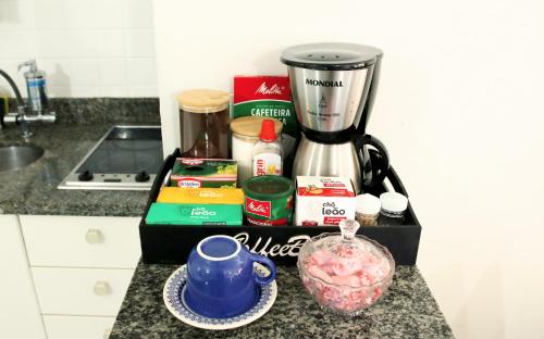 a kitchen counter with a blender and ingredients on it at Flats em frente ao Allianz Parque - HOTEL EM PERDIZES in Sao Paulo