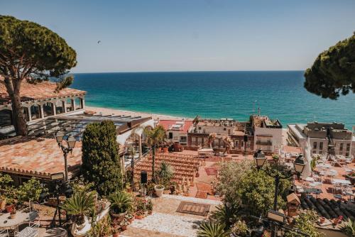 a view of a town with the ocean in the background at Hotel Roger de Flor by Seleqtta in Lloret de Mar