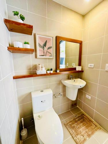 a bathroom with a toilet and a sink at The Palladium Iloilo near Convention Center Studio unit with private balcony City View studio only in Iloilo City