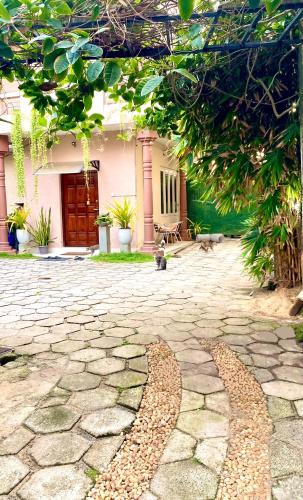 a house with a stone walkway in front of a building at Villa Two Residence in Mount Lavinia