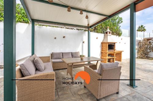 a patio with two chairs and a table with a fireplace at #245 Quinta do Julo by Home Holidays in Albufeira