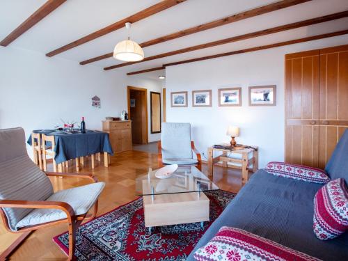 a living room with a couch and a table at Apartment Diamant 39 by Interhome in Villars-sur-Ollon