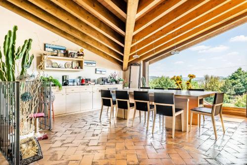 a kitchen with a wooden ceiling and a table and chairs at LA FOLAGA b&b in Gavirate