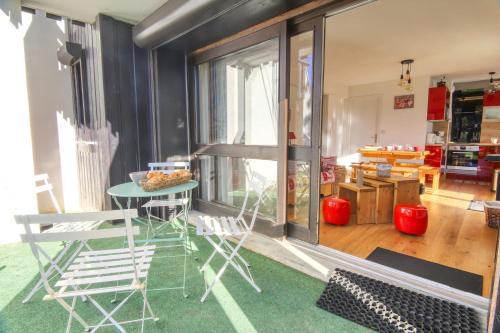 a living room with a table and chairs in a room at Comte Rouge in Taninges