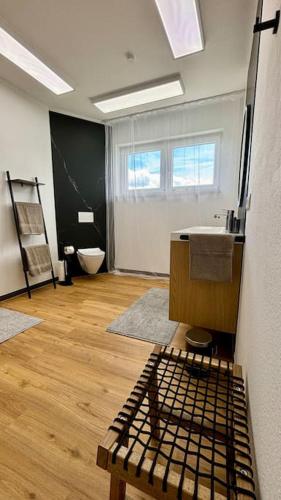 a bathroom with a sink and a toilet in a room at Ferienhaus - Das Seigendorfer in Hirschaid