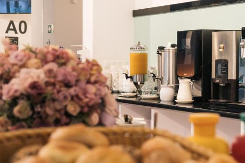 Una cocina con encimera con cafetera y flores. en Henryk, en Świnoujście