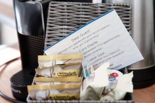 a basket with a piece of paper next to a coffee maker at Lario Suite Apartments by Quokka 360 - With parking Next to Como City in Como