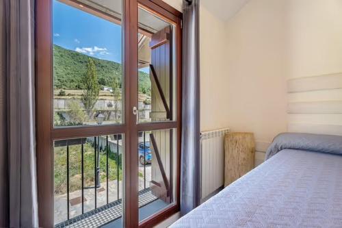 Ένα ή περισσότερα κρεβάτια σε δωμάτιο στο Chalet Hot tub EVcharger Formigal 30min BBQ