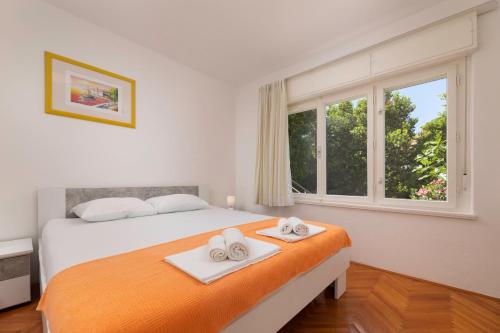 a bedroom with a bed with two towels on it at Villa Joy in Jadranovo