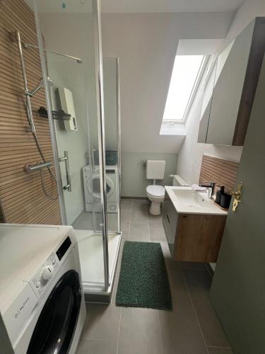a bathroom with a sink and a washing machine at 3 Zimmer Monteurewohnung in Kirchhain in Kirchhain