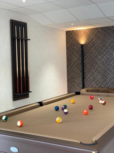 a pool table with balls on top of it at Hôtel Breizh Du Golfe in Arzon