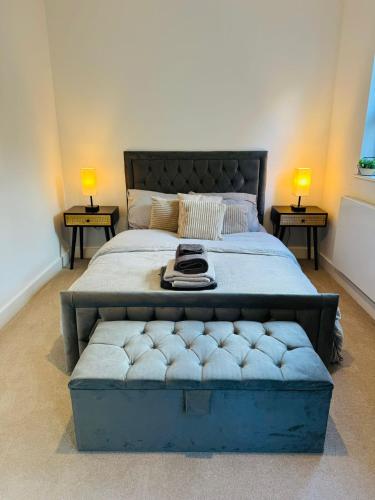 a bedroom with a large bed with two end tables at #13 Elegant Solihull Townhouse - Sleeps 10 - NEC BHX - "Perfect for Contractors and Families - Fee Parking in Olton