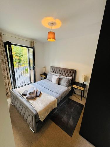 a bedroom with a large bed with a large window at #13 Elegant Solihull Townhouse - Sleeps 10 - NEC BHX - "Perfect for Contractors and Families - Fee Parking in Olton