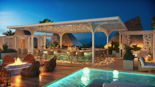 a resort with a pool and a deck with a bar at W Punta Cana, Adult All-Inclusive in Punta Cana