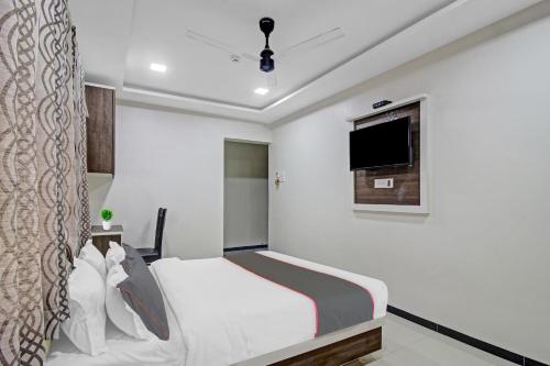 a bedroom with a bed and a flat screen tv at Hotel O Raj Mahal in Turambhe