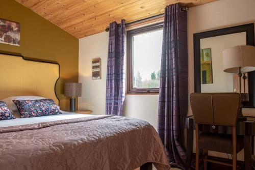 a bedroom with a bed and a window at Harvest 18 Lodge, Yellowtop Country Park in Selby